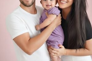 Young couple put daughter inside the fir… See more