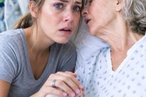 While my grandmother lay dying, my parents and sister never visited—not once. I was the only one holding her hand when she whispered, “After I’m gone, look behind the family portrait in the living room.”